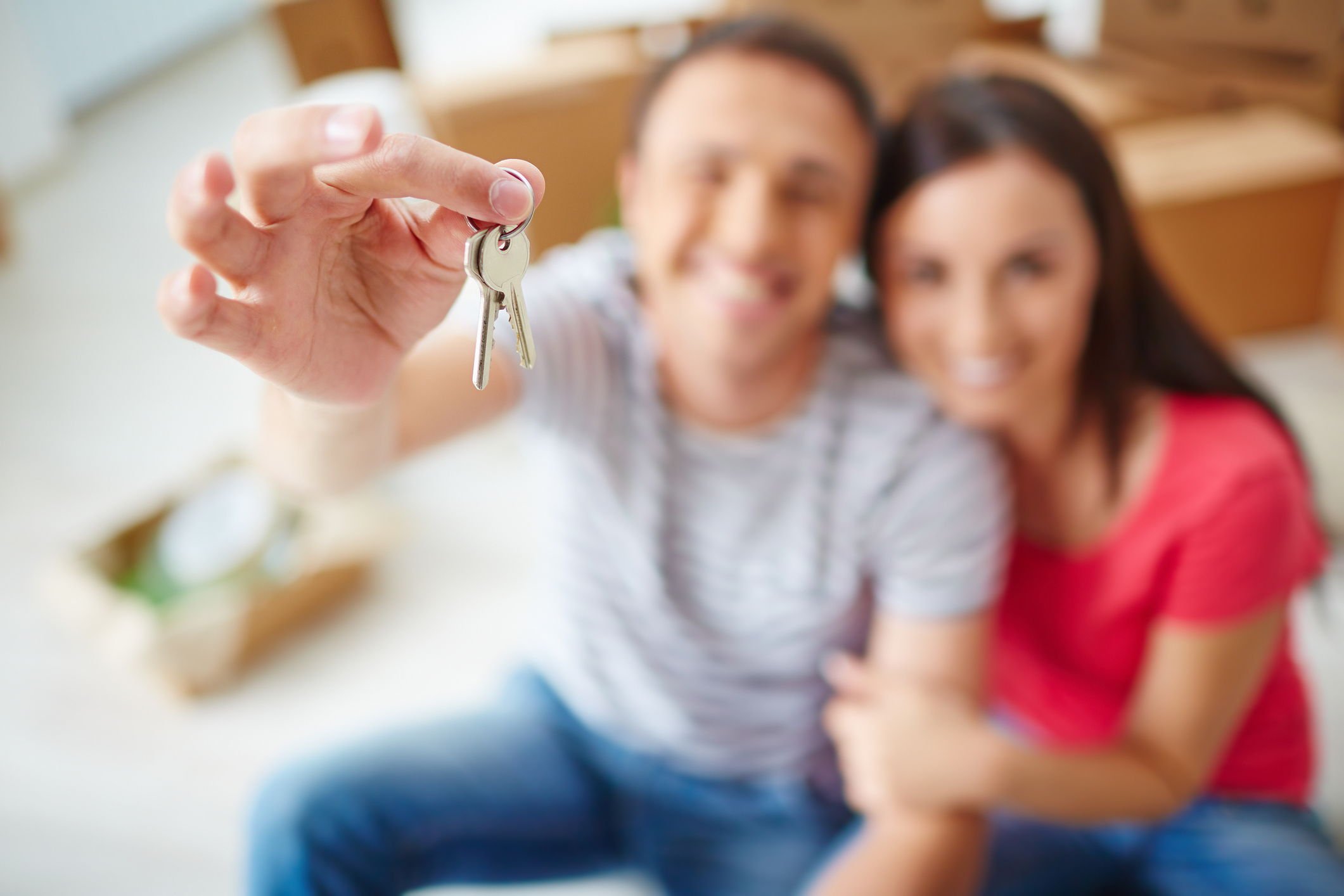 Couple holding out new set of keys