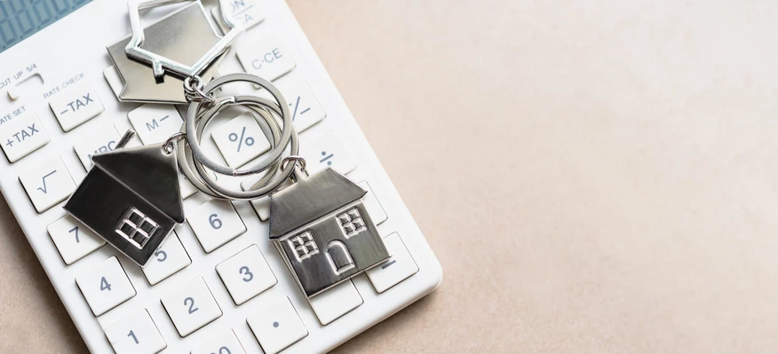 House keychains sitting on top of calculator
