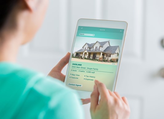Person house shopping on a tablet