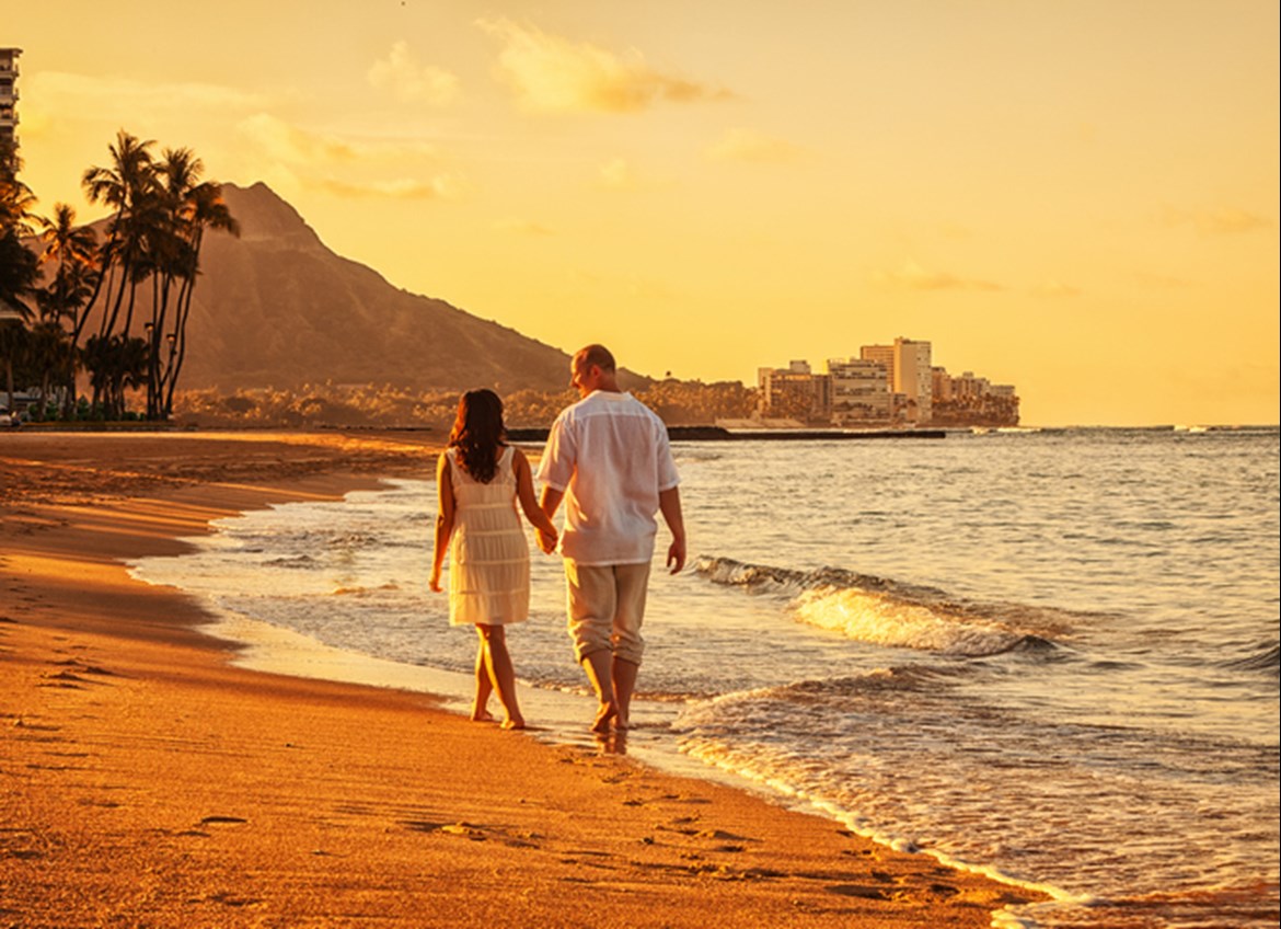 Couple walking on beach in Honolulu