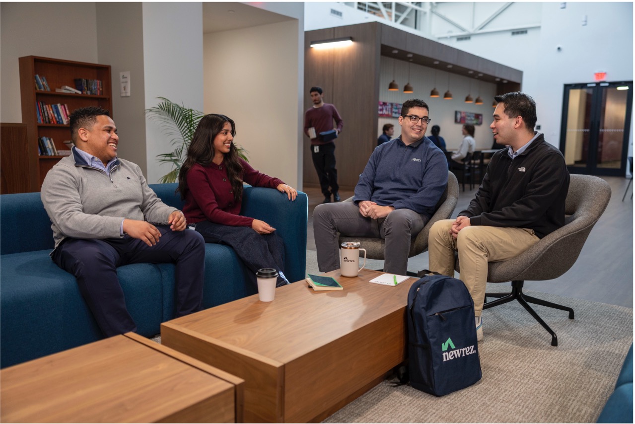 Coworkers chatting in an office lounge.