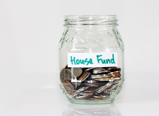 House fund jar with coins inside