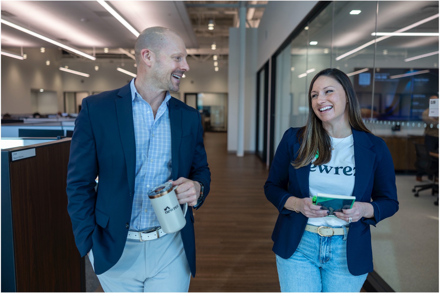 Two Newrez employees walking and talking