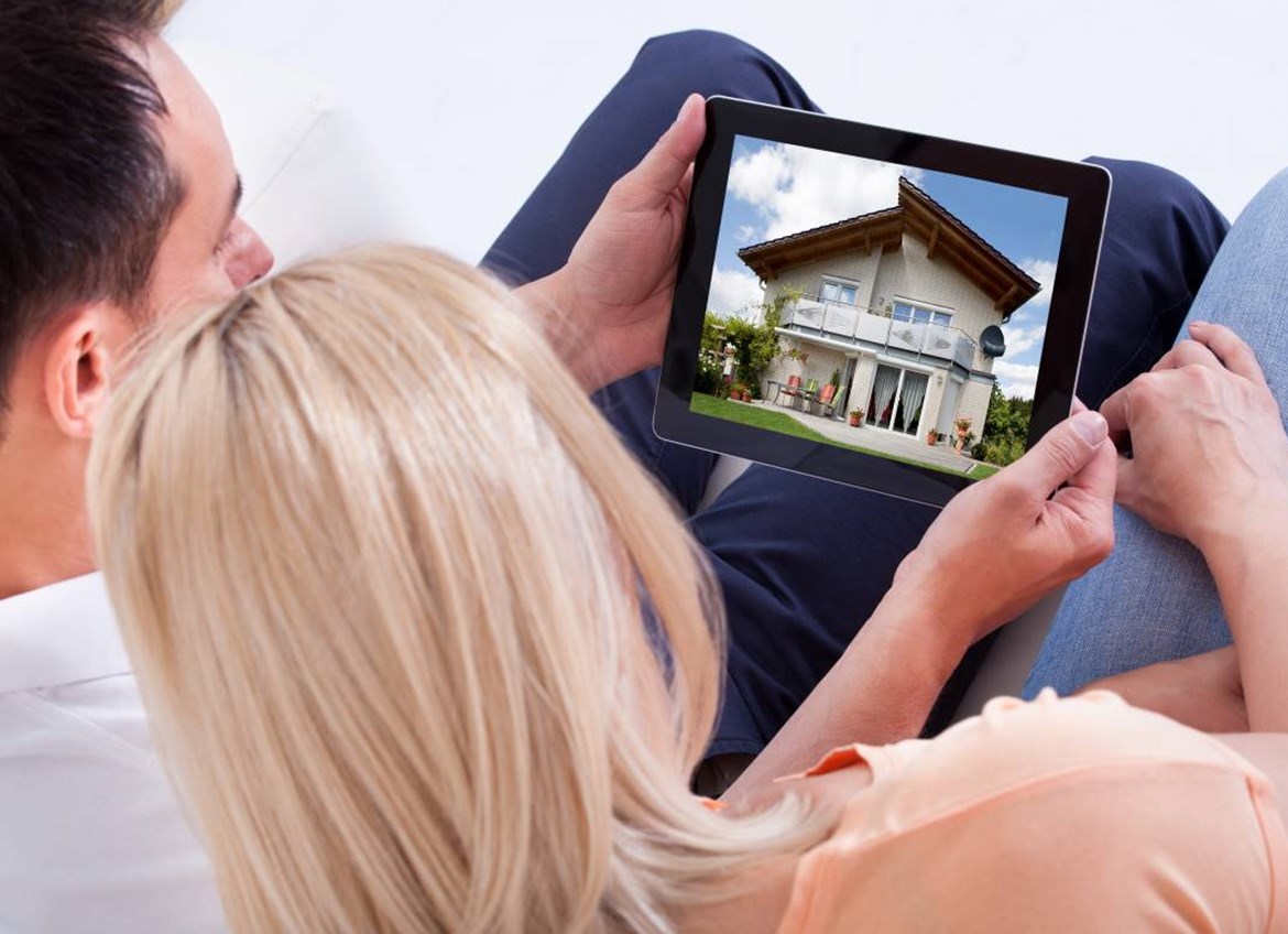 Couple looking at house on iPad